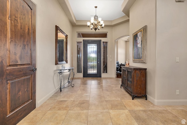 373 W Meridian Dr, Ivins, UT 84738 - entryway featuring a chandelier, arched walkways, light tile patterned flooring, and a raised ceiling