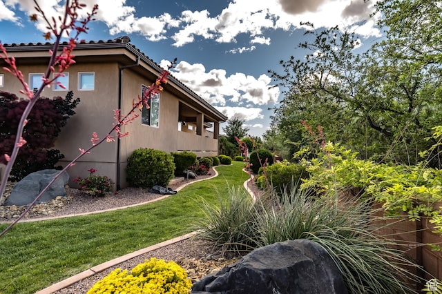 373 W Meridian Dr, Ivins, UT 84738 - view of side of property with a lawn and stucco siding