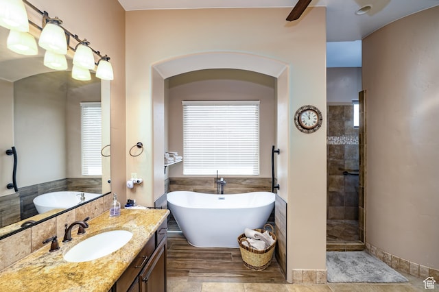373 W Meridian Dr, Ivins, UT 84738 - full bathroom featuring healthy amount of natural light, a soaking tub, and vanity