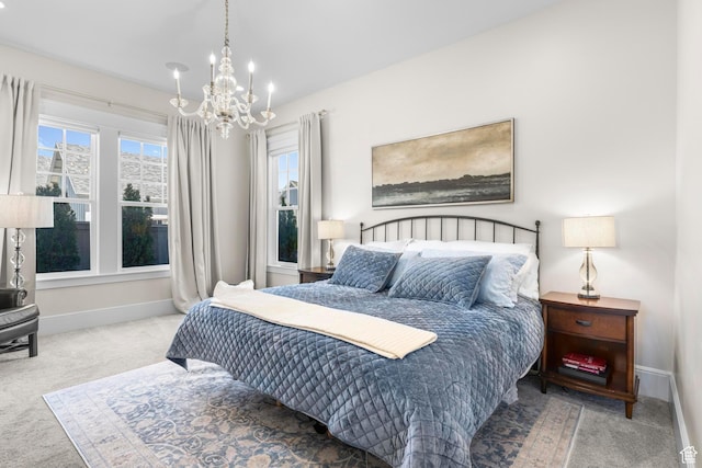 bedroom with carpet floors, a chandelier, and baseboards