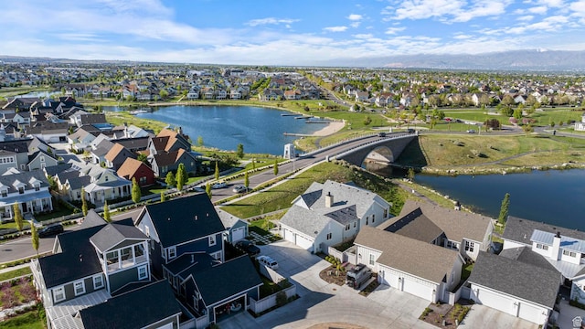 aerial view of residential area featuring a water and mountain view