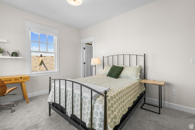 carpeted bedroom featuring baseboards