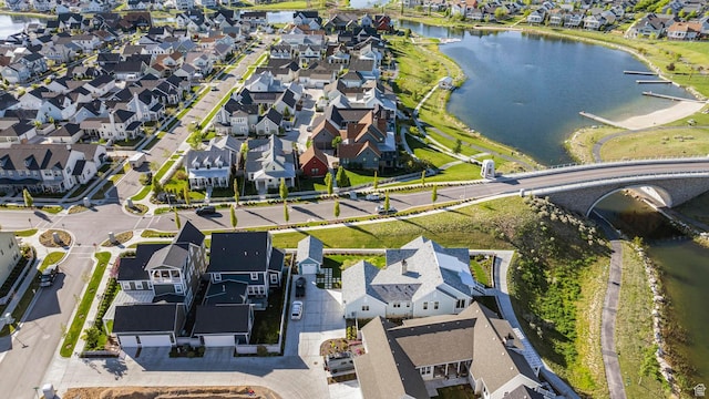 aerial view of residential area featuring a large body of water
