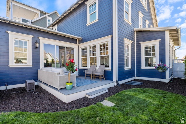 back of house featuring outdoor lounge area and a wooden deck