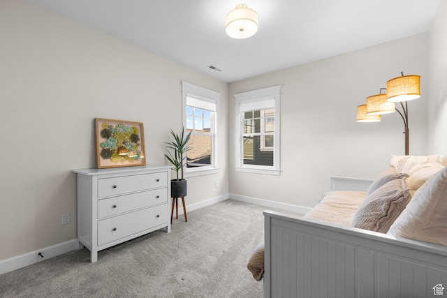 bedroom featuring light colored carpet and baseboards