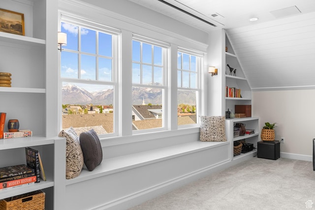 living area featuring carpet flooring, vaulted ceiling, a mountain view, baseboards, and wooden ceiling