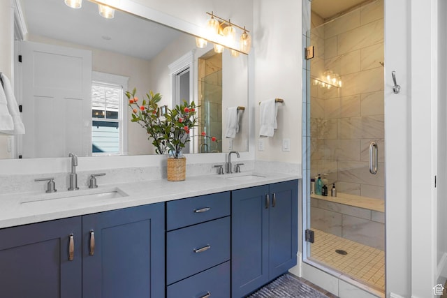 full bathroom with a shower stall and double vanity