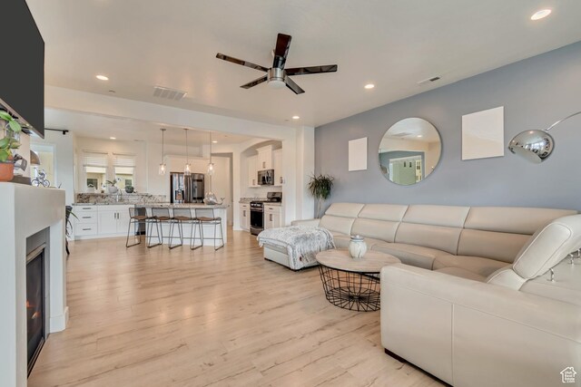 11233 S Clear Blue Dr Unit 402, South Jordan, UT 84009 - living room with light wood-style floors, recessed lighting, and a ceiling fan