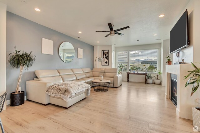 11233 S Clear Blue Dr Unit 402, South Jordan, UT 84009 - living area with ceiling fan, recessed lighting, light wood-style flooring, and a glass covered fireplace