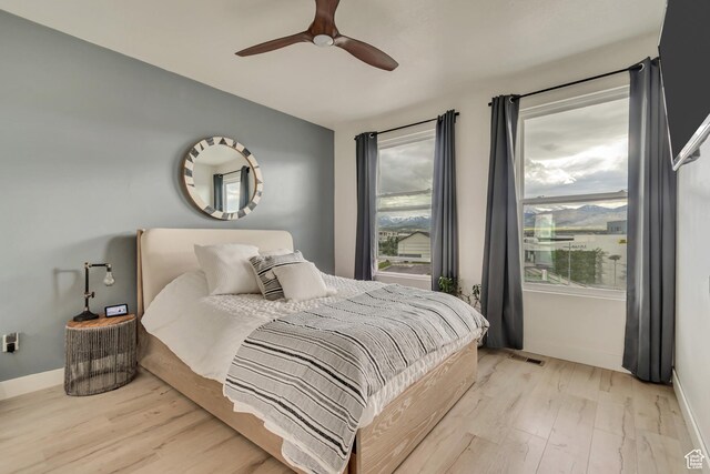 11233 S Clear Blue Dr Unit 402, South Jordan, UT 84009 - bedroom featuring light wood-style flooring, baseboards, and ceiling fan