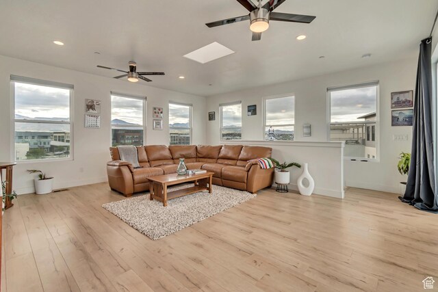 11233 S Clear Blue Dr Unit 402, South Jordan, UT 84009 - living room with ceiling fan, wood finished floors, recessed lighting, a skylight, and baseboards