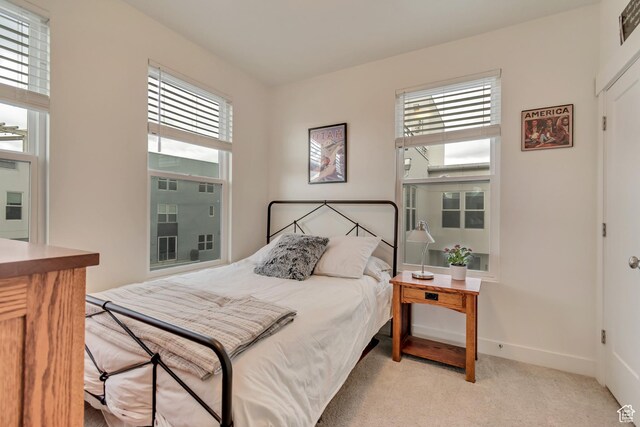 11233 S Clear Blue Dr Unit 402, South Jordan, UT 84009 - bedroom with multiple windows, light carpet, and baseboards