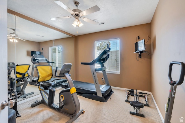 exercise room with ceiling fan, baseboards, and carpet floors