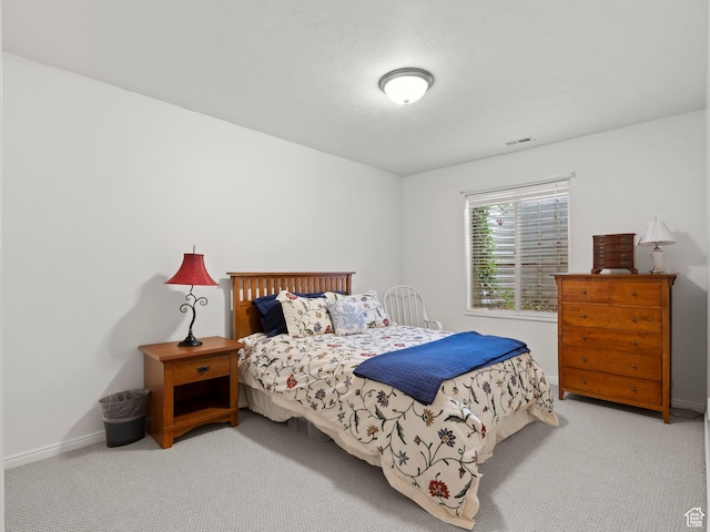 carpeted bedroom featuring baseboards