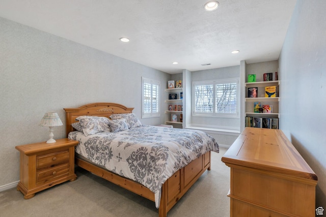 bedroom featuring light colored carpet and recessed lighting
