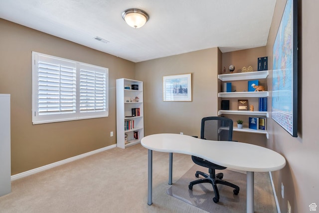 carpeted office space featuring baseboards