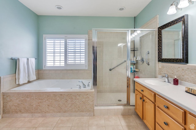 bathroom with vanity, a shower stall, tile patterned flooring, and a garden tub