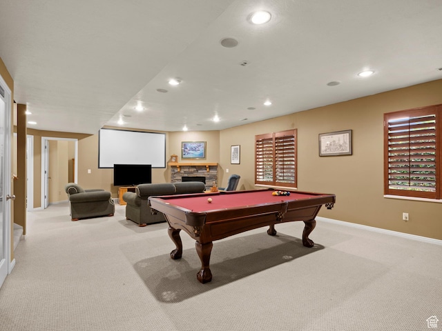 game room featuring light colored carpet, recessed lighting, billiards table, baseboards, and a stone fireplace