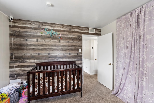 bedroom with wood walls and carpet floors