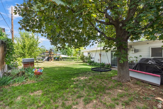 view of grassy yard featuring a playground