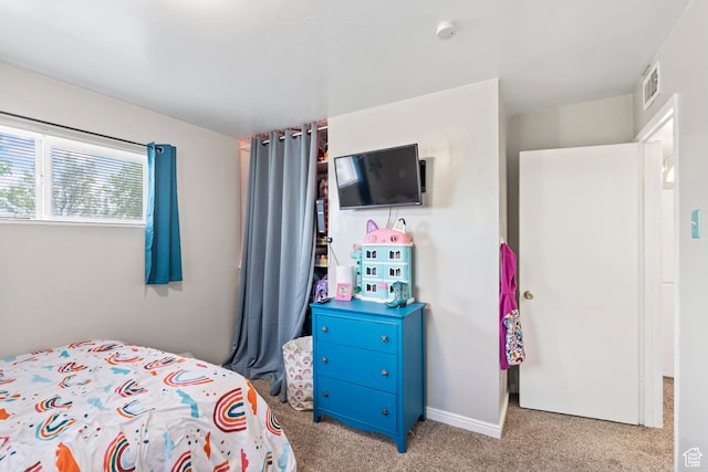 carpeted bedroom featuring baseboards