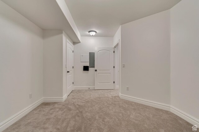 carpeted empty room with baseboards
