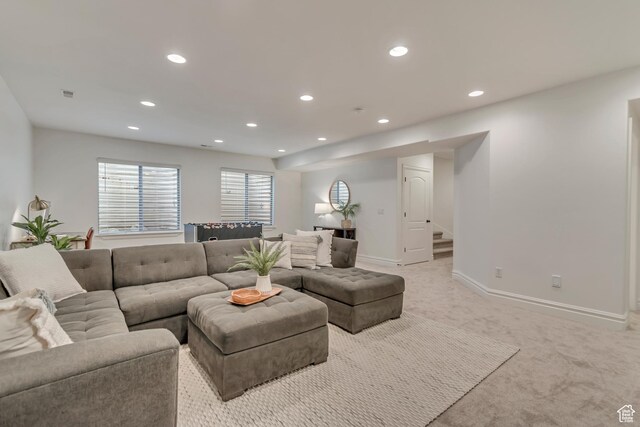 living area with light colored carpet, stairway, recessed lighting, and baseboards