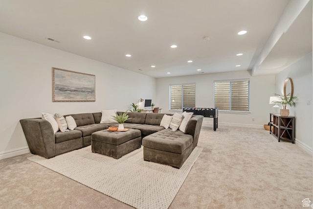 living area featuring light colored carpet, recessed lighting, and baseboards