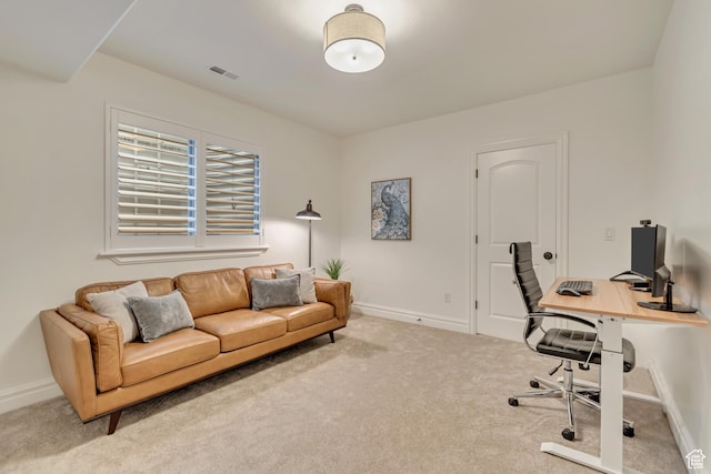carpeted home office with baseboards