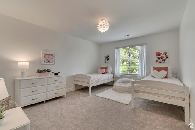 bedroom with light colored carpet