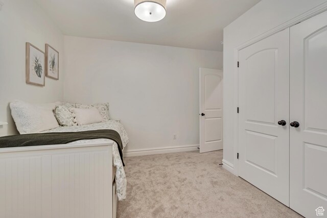 bedroom featuring carpet flooring, baseboards, and a closet