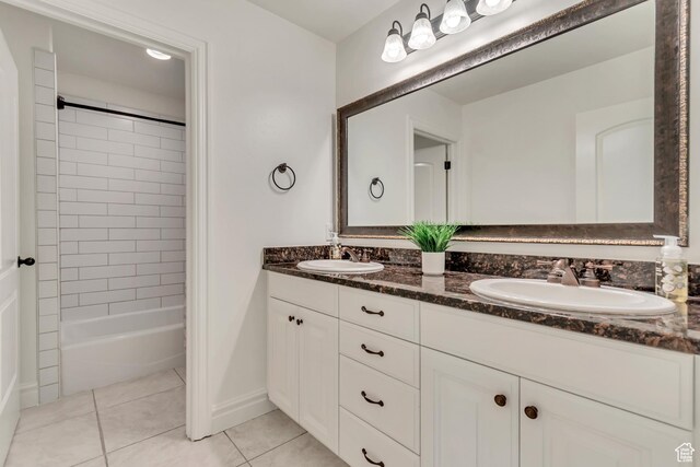 full bathroom with tile patterned flooring, double vanity, and baseboards