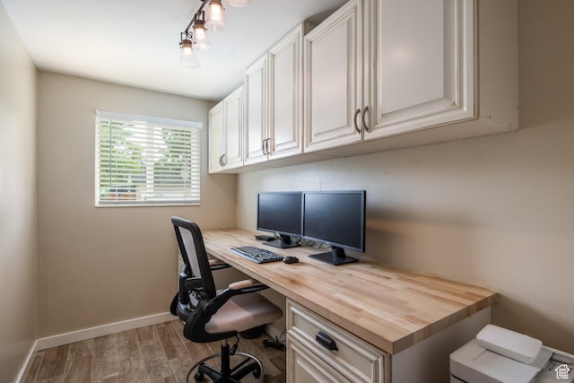 1256 E Darby Cir S, Murray, UT 84117 - office area featuring wood finished floors, built in study area, and baseboards