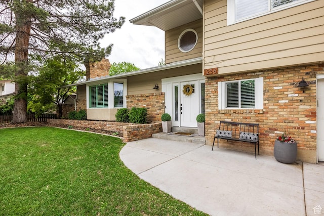 1256 E Darby Cir S, Murray, UT 84117 - property entrance featuring a lawn, a chimney, and brick siding