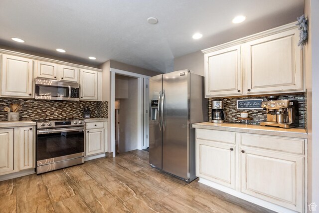 1256 E Darby Cir S, Murray, UT 84117 - kitchen with appliances with stainless steel finishes, backsplash, light countertops, and recessed lighting