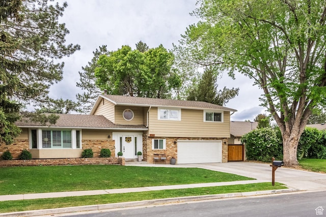 1256 E Darby Cir S, Murray, UT 84117 - view of front facade with brick siding, driveway, and an attached garage