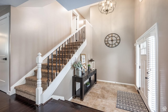 1256 E Darby Cir S, Murray, UT 84117 - foyer entrance featuring a towering ceiling, baseboards, stairs, and a chandelier