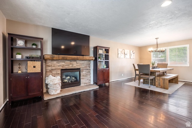 1256 E Darby Cir S, Murray, UT 84117 - living area with baseboards, wood finished floors, a chandelier, a textured ceiling, and a stone fireplace