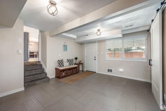 1256 E Darby Cir S, Murray, UT 84117 - foyer entrance with a barn door, stairs, baseboards, and beam ceiling