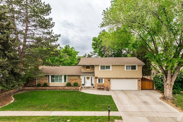 1256 E Darby Cir S, Murray, UT 84117 - tri-level home featuring driveway, a garage, and brick siding