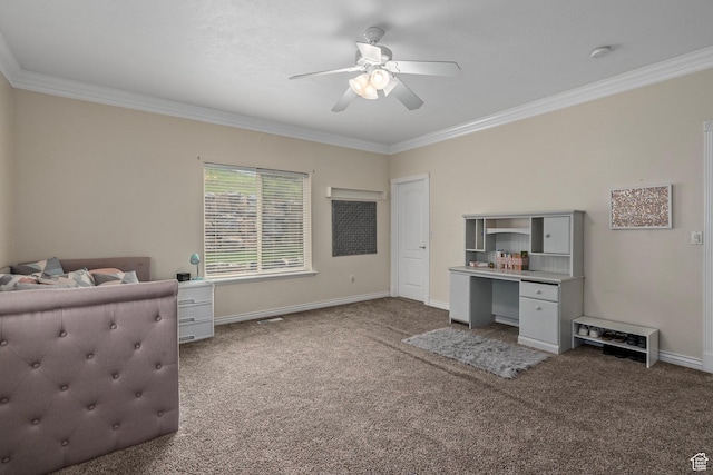 carpeted bedroom with crown molding, baseboards, ceiling fan, and a desk