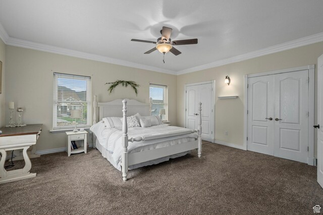 carpeted bedroom featuring crown molding, multiple windows, baseboards, and a ceiling fan