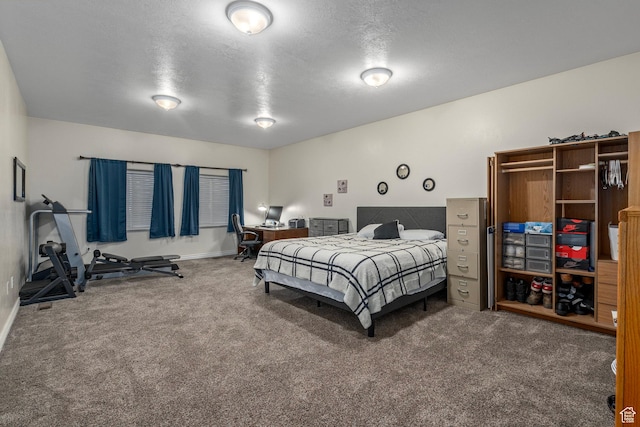 carpeted bedroom with baseboards and a textured ceiling