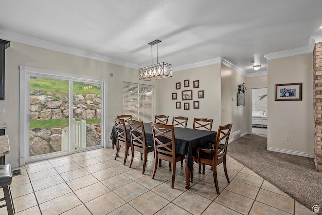 dining room with light tile patterned floors, a chandelier, crown molding, light colored carpet, and baseboards