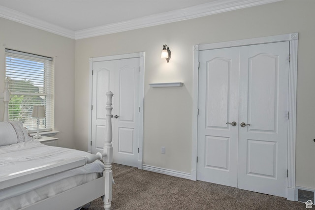 bedroom with carpet floors, crown molding, and baseboards