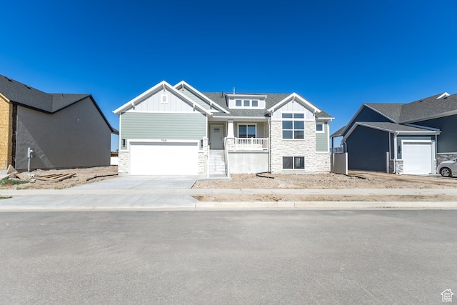 709 S 3575 W Unit 147, West Weber, UT 84401 - craftsman house featuring board and batten siding, a garage, stone siding, concrete driveway, and a porch