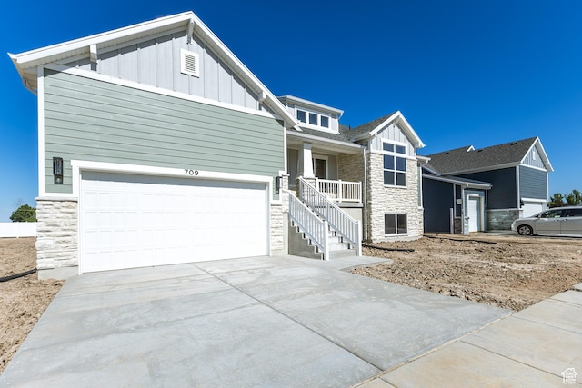 709 S 3575 W Unit 147, West Weber, UT 84401 - craftsman house with stone siding, board and batten siding, concrete driveway, and covered porch