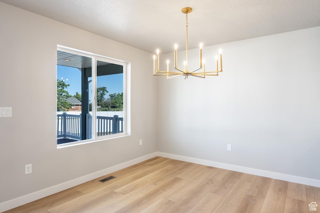 709 S 3575 W Unit 147, West Weber, UT 84401 - spare room with a chandelier and light wood-type flooring