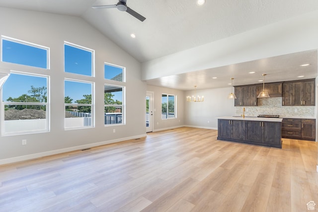 709 S 3575 W Unit 147, West Weber, UT 84401 - unfurnished living room featuring a chandelier, high vaulted ceiling, ceiling fan, light wood-type flooring, and recessed lighting