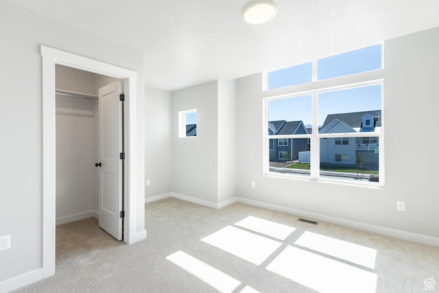 709 S 3575 W Unit 147, West Weber, UT 84401 - unfurnished bedroom featuring carpet floors and a walk in closet